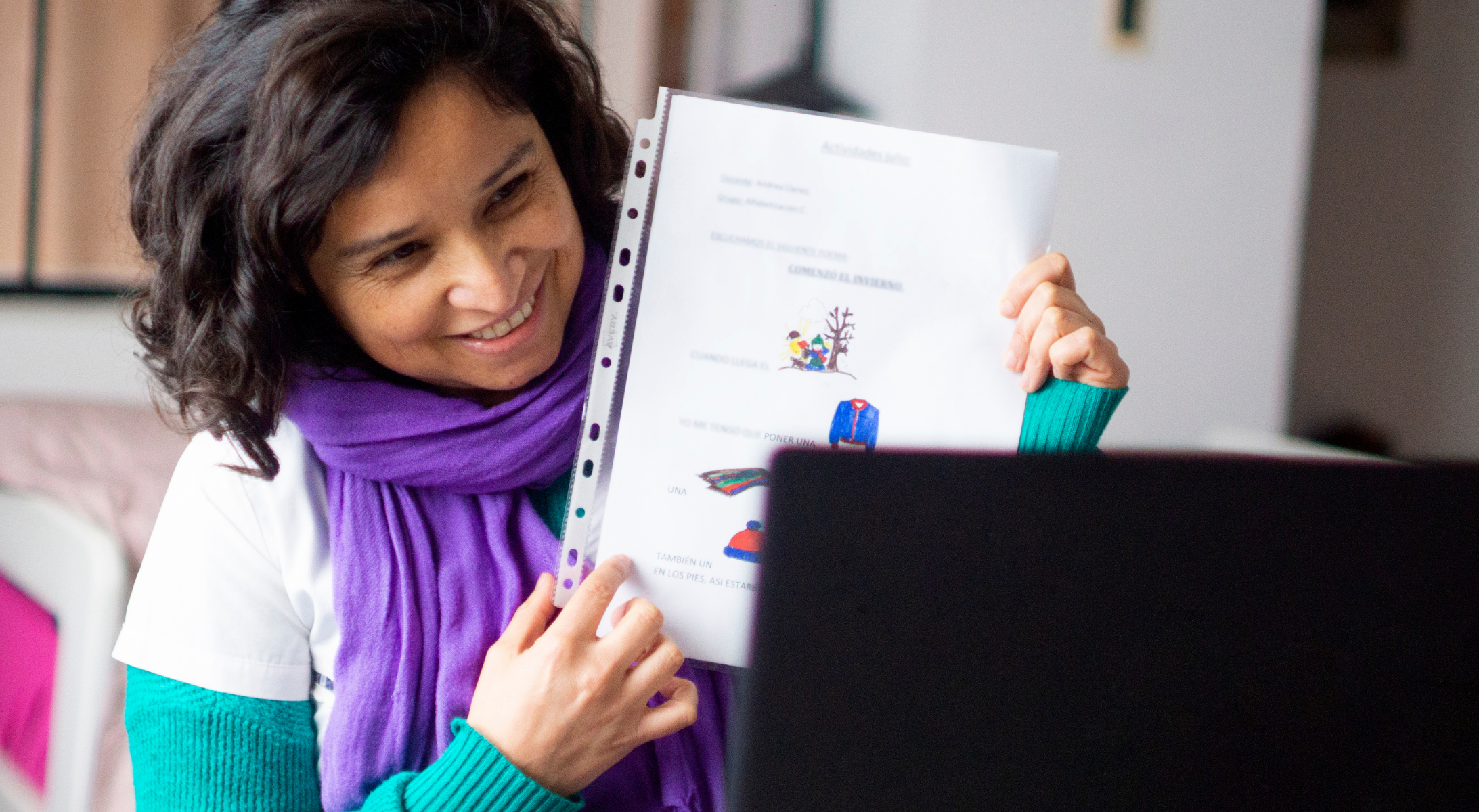A teacher shows students lesson material via video during hybrid learning.