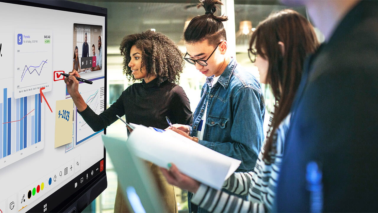 Team of diverse professionals collaboratively using a SMART interactive display to review and discuss digital data and video conferencing.