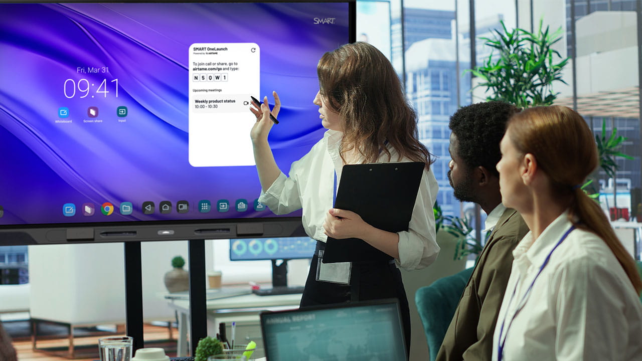 Presenter using SMART Pen to interact with the SMART OneLaunch widget on a QX Pro display during a meeting.