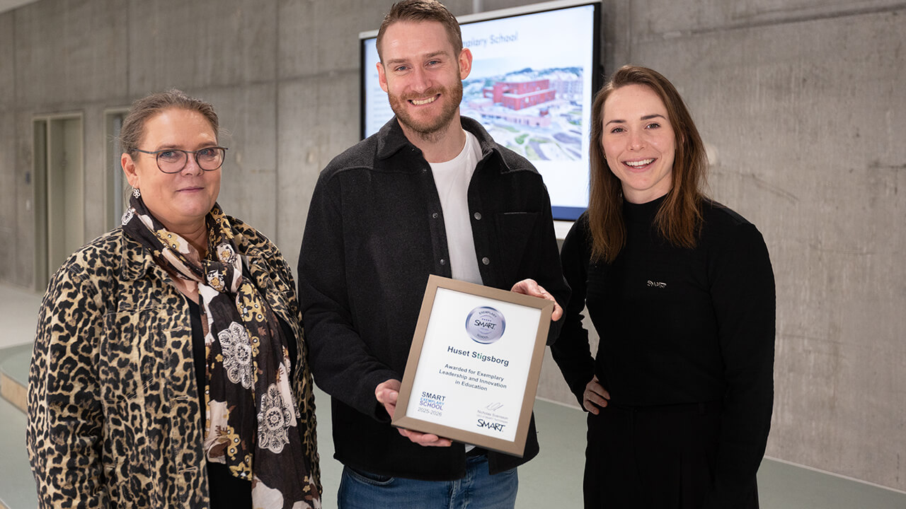Stigsborg teachers accepting a SMART Exemplary School award