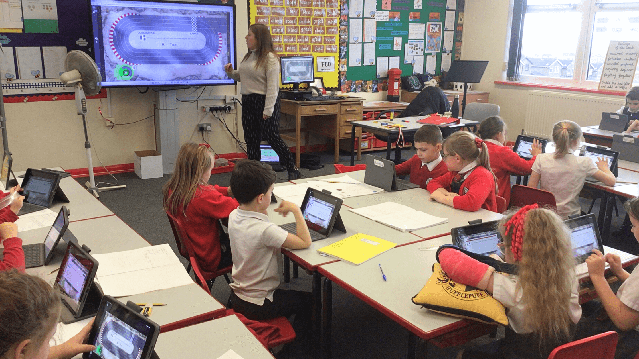 Students engaged on their devices in their classroom.