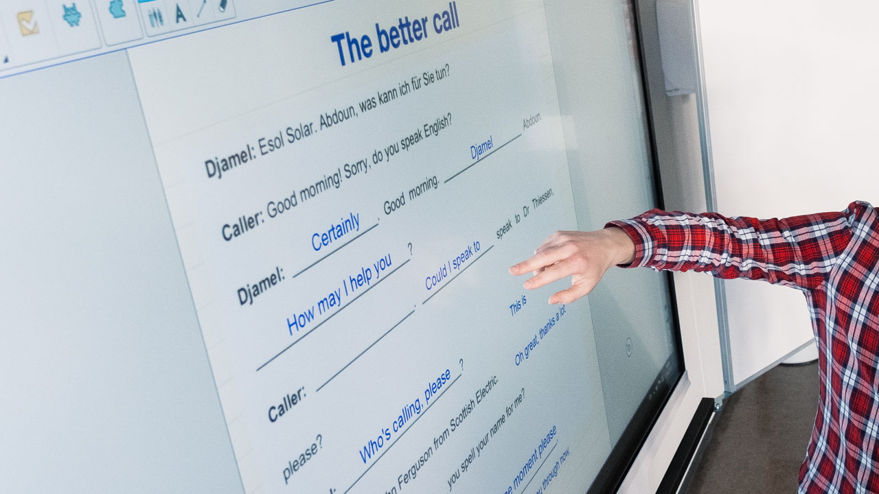 An interactive lesson on English dialogues displayed on a SMART Board.