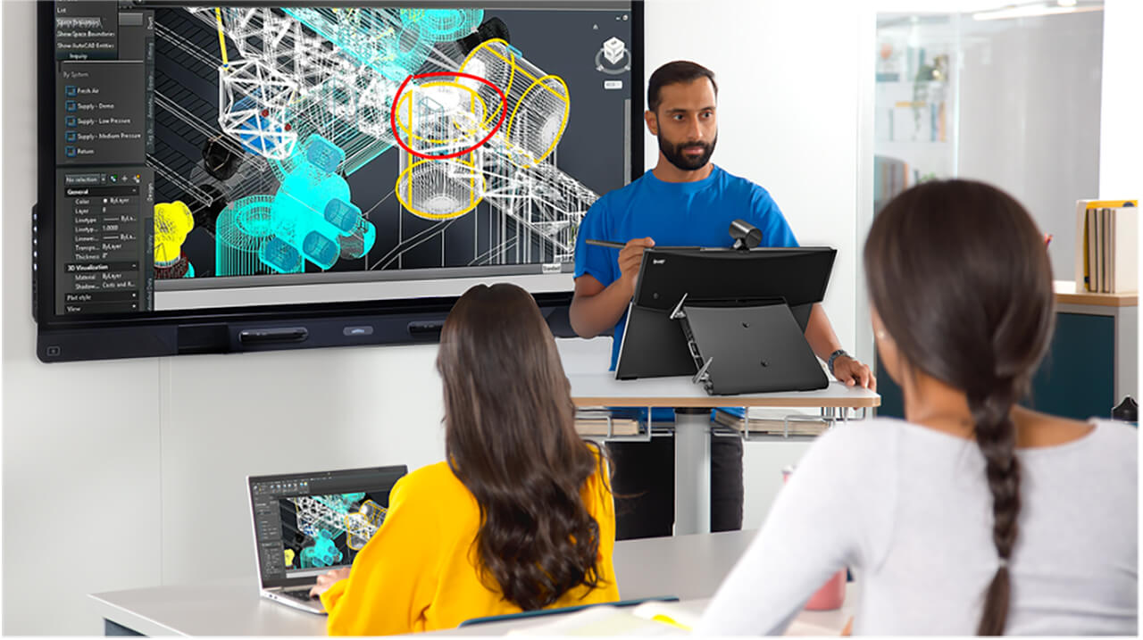 Instructor using a SMART Board Mini display to review a 3D engineering design model while learners follow along from classroom devices.