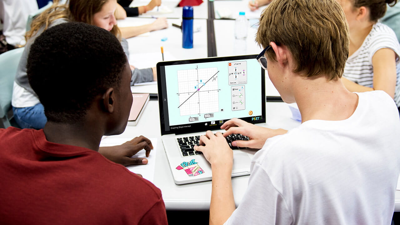 Students in a STEM lab using software on a laptop