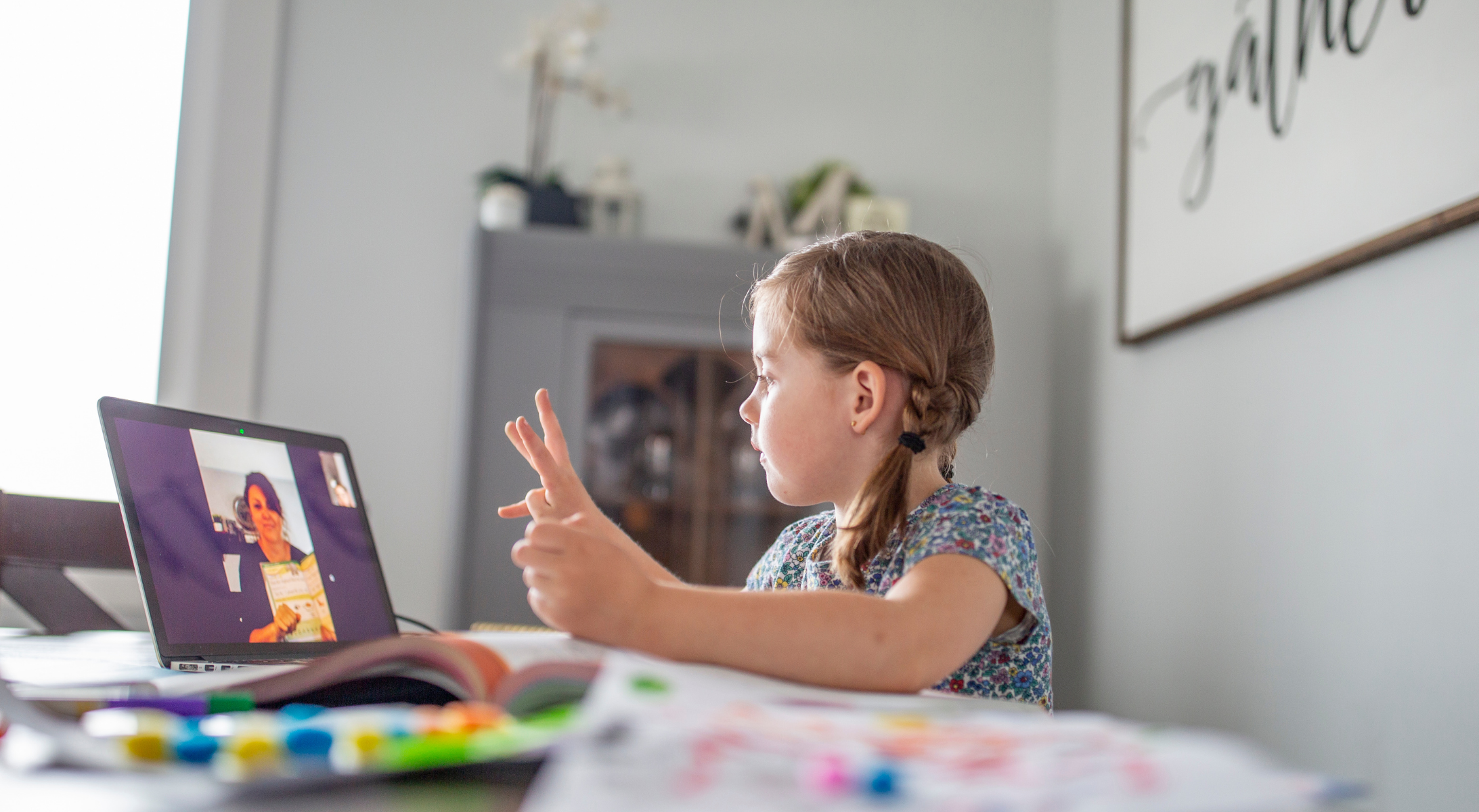 An elementary student participates in a remote classroom lesson during lockdown.