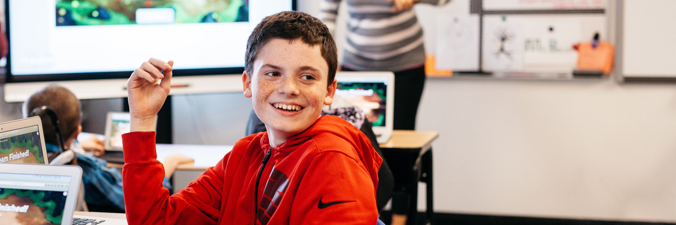 A young student laughing as he completes a Monster Quiz in Lumio.
