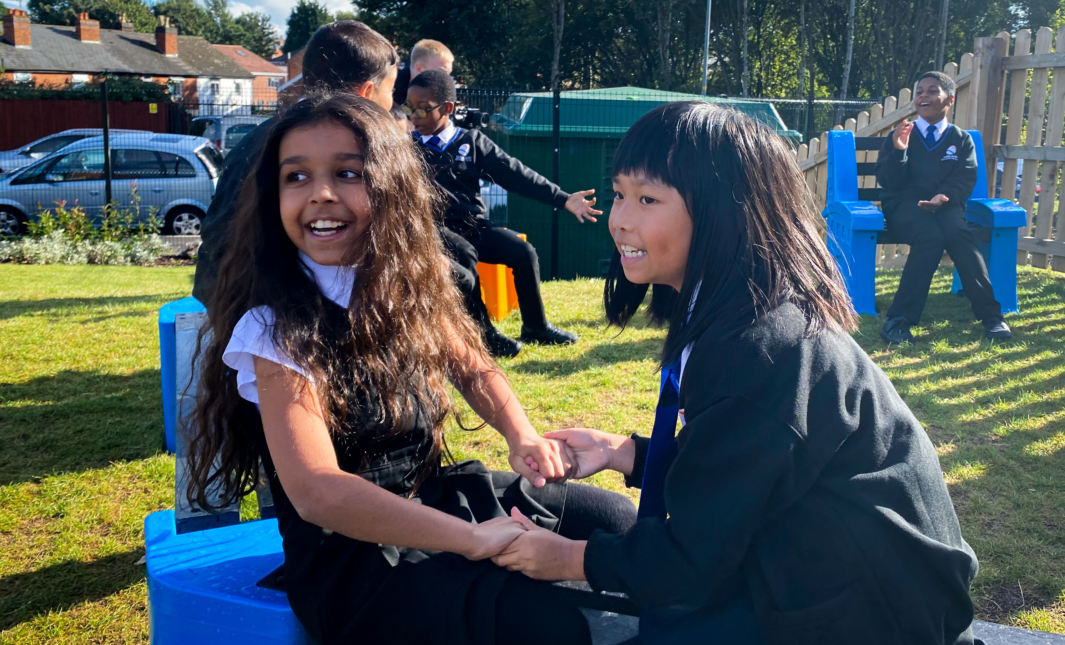 Two students engage socially during recess at school.