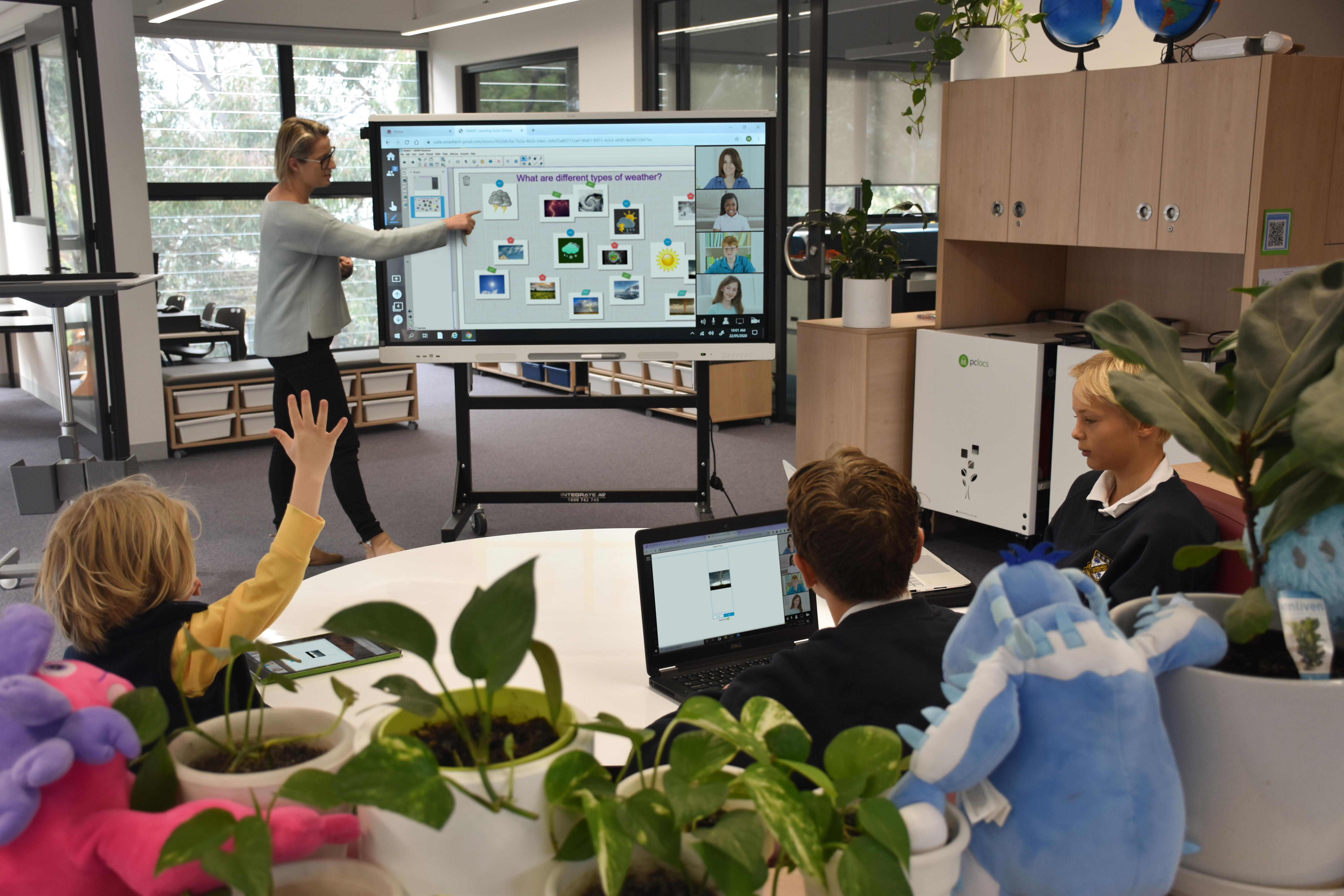 A teacher facilitates a lesson using blended learning strategies in Australia.