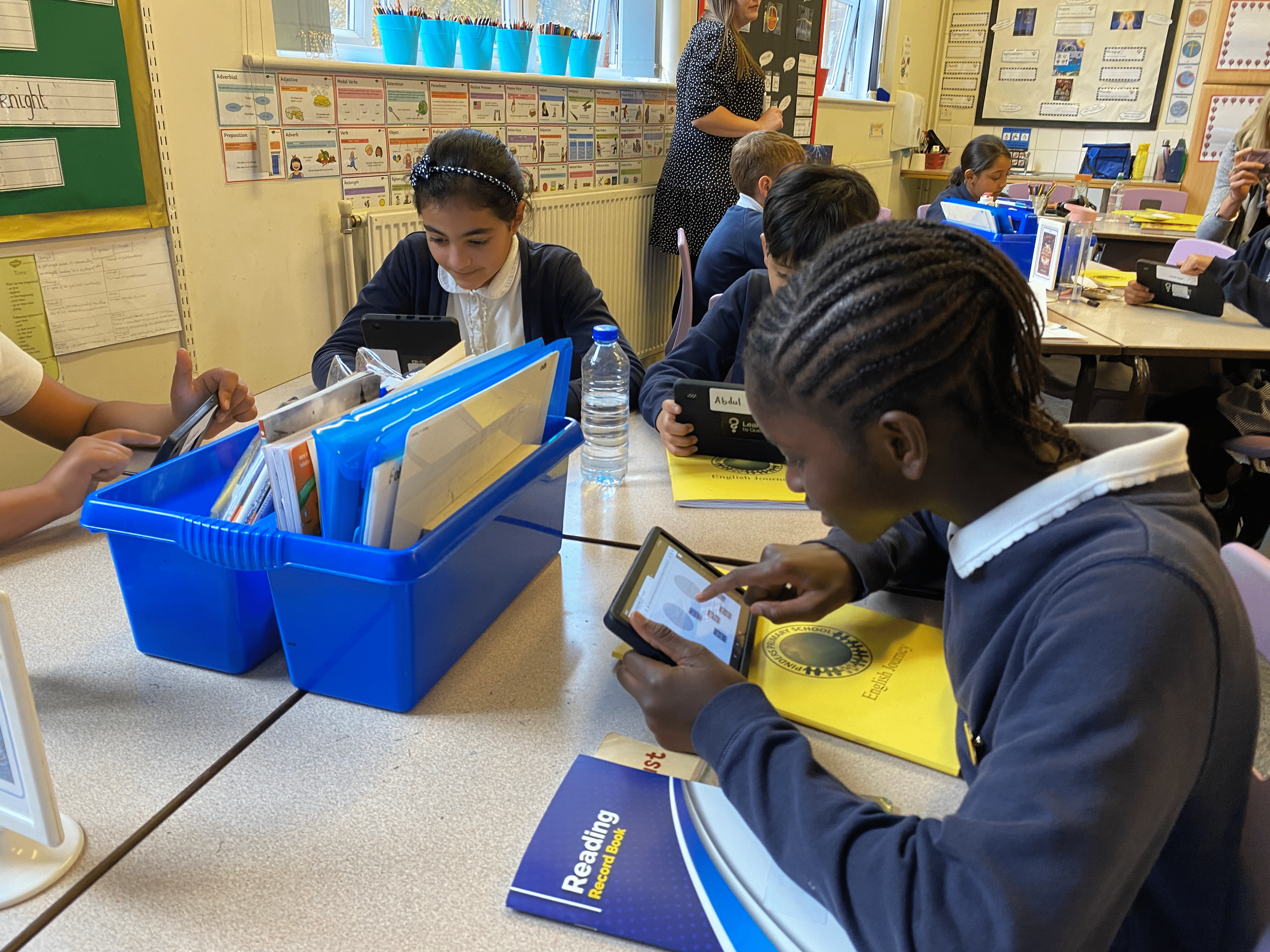 Students engaged on their devices in their classroom.