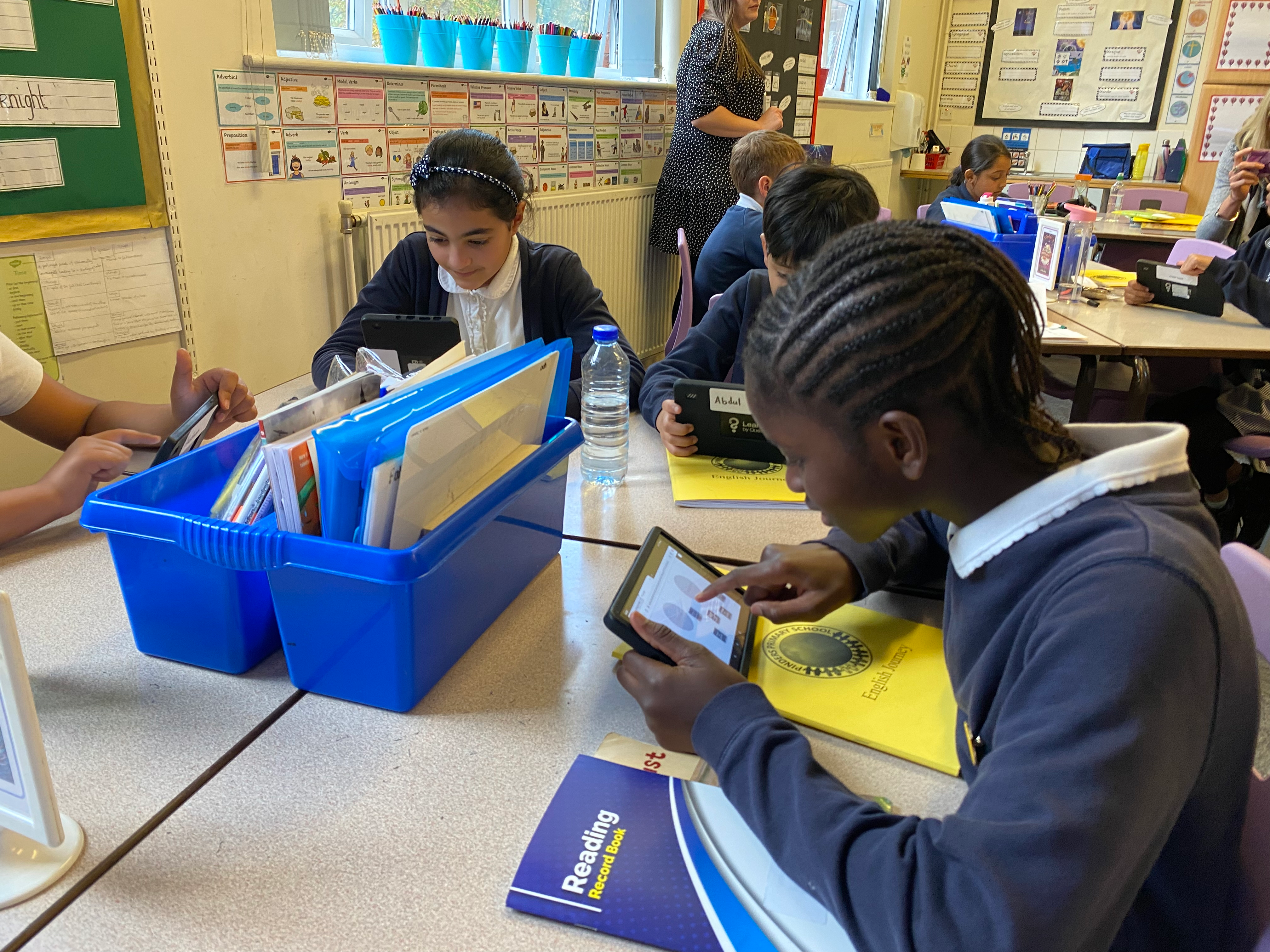 Students engaged on their devices in their classroom.