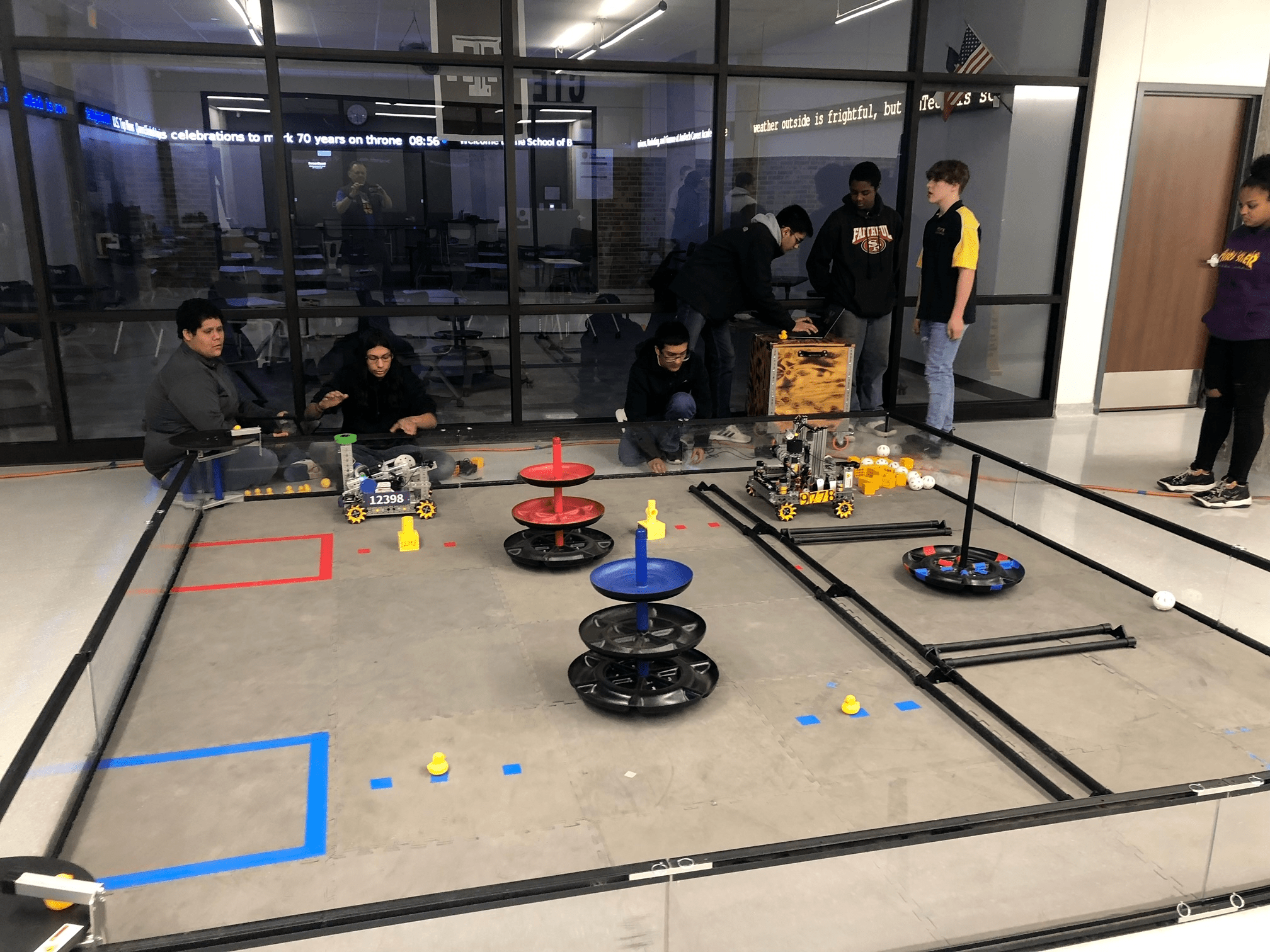 students gathering around robot at the AmTech Career Academy in Texas