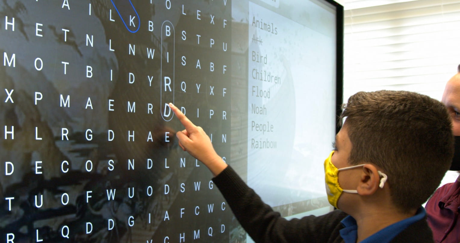 Students working on a SMART board