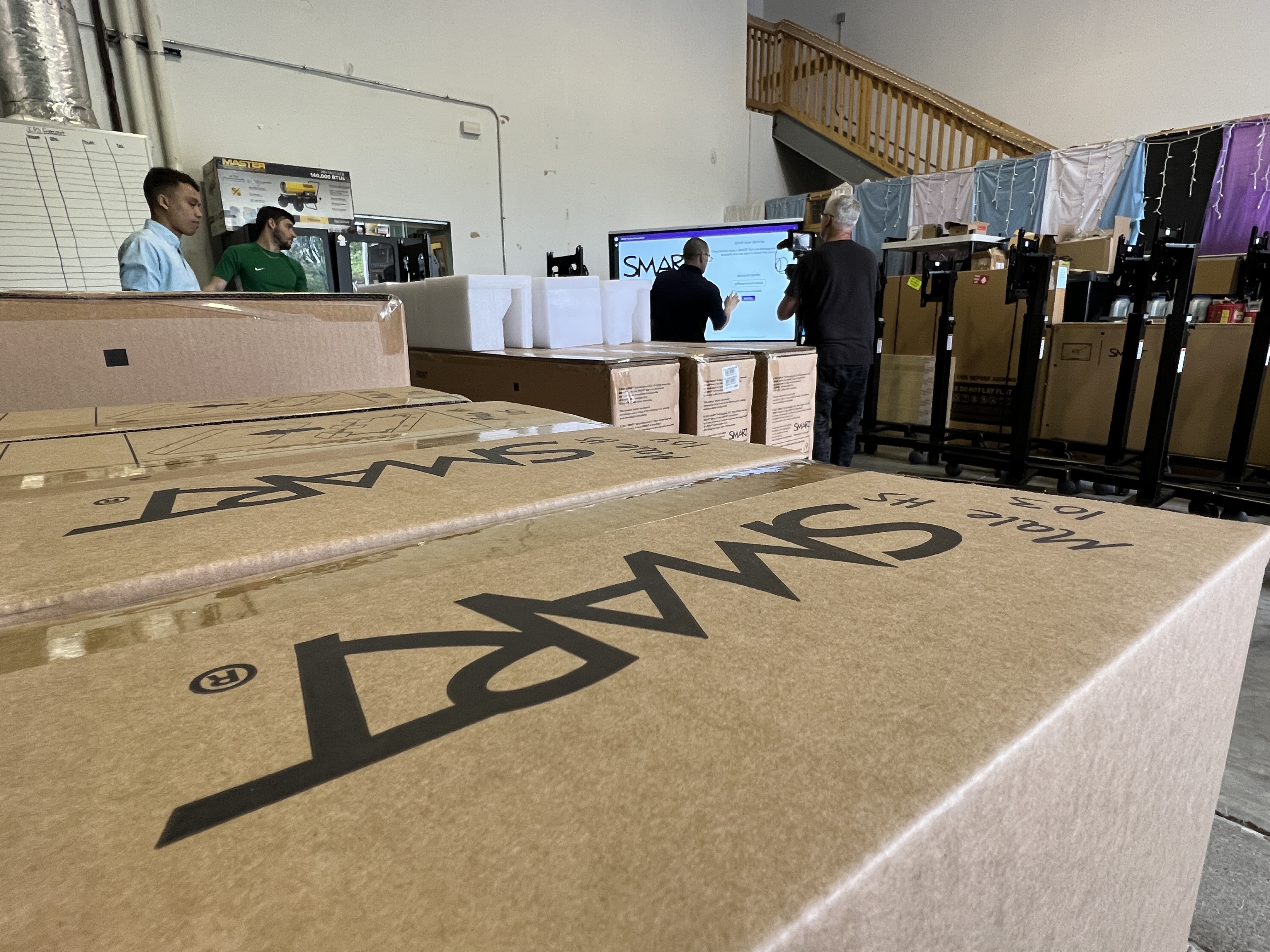 Boxes labeled SMART being unpacked in a warehouse during installation.