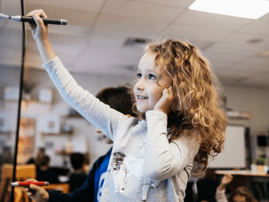 Young student using a SMART board