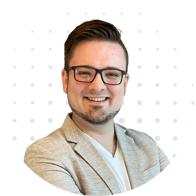 Chad Visser smiling in a professional headshot with a white polka-dot background.