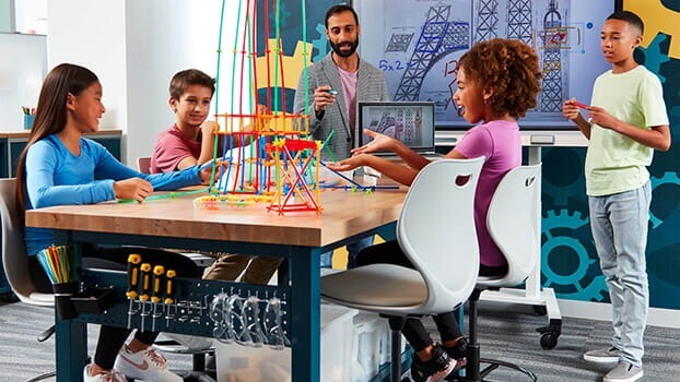 Students in a classroom learning with a SMART Board